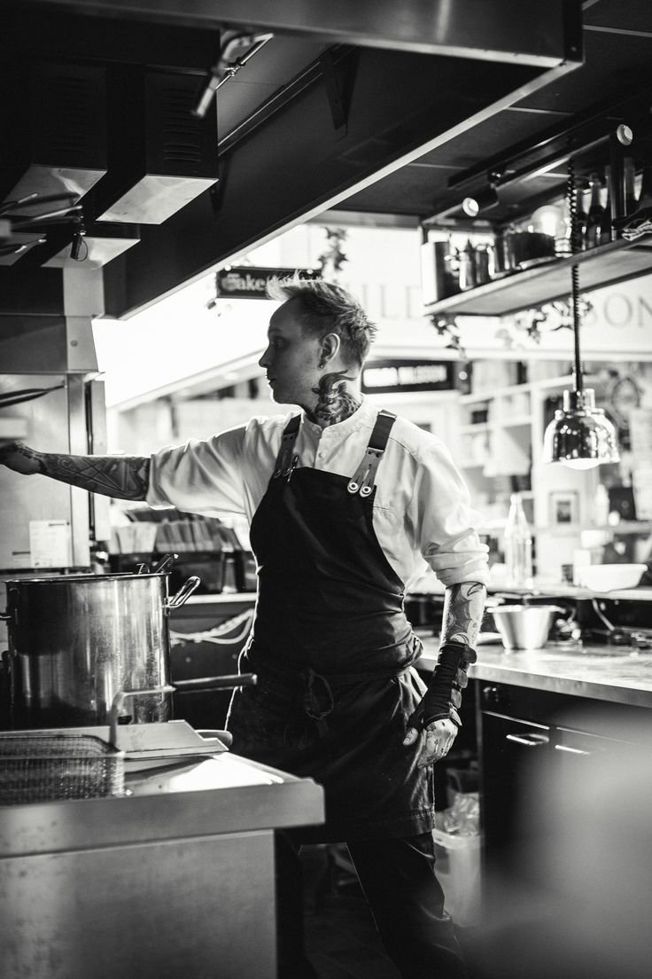 Chef leading service in an open kitchen