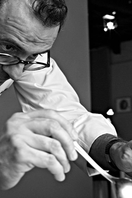 Close-up of a chef finishing a dish